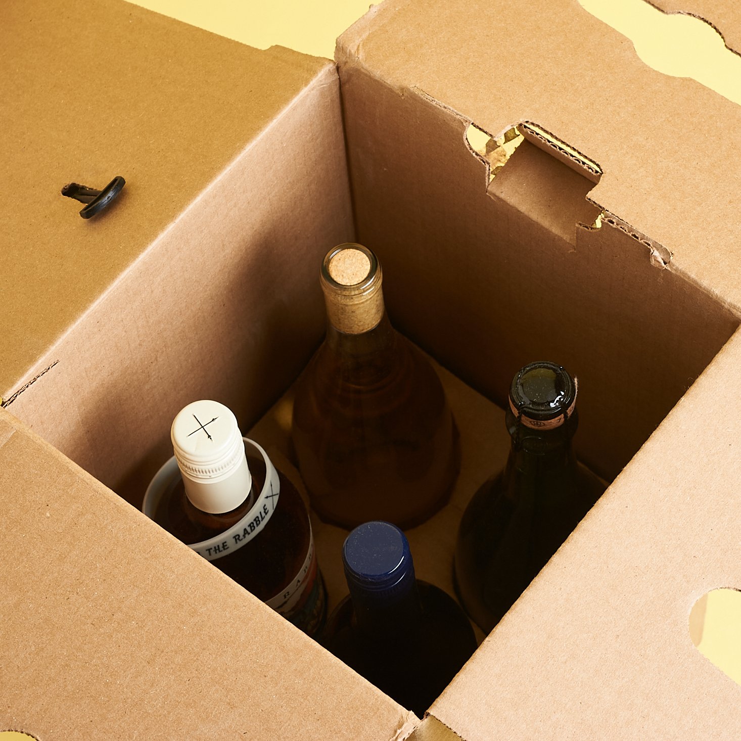 view of four upright bottles inside of the box