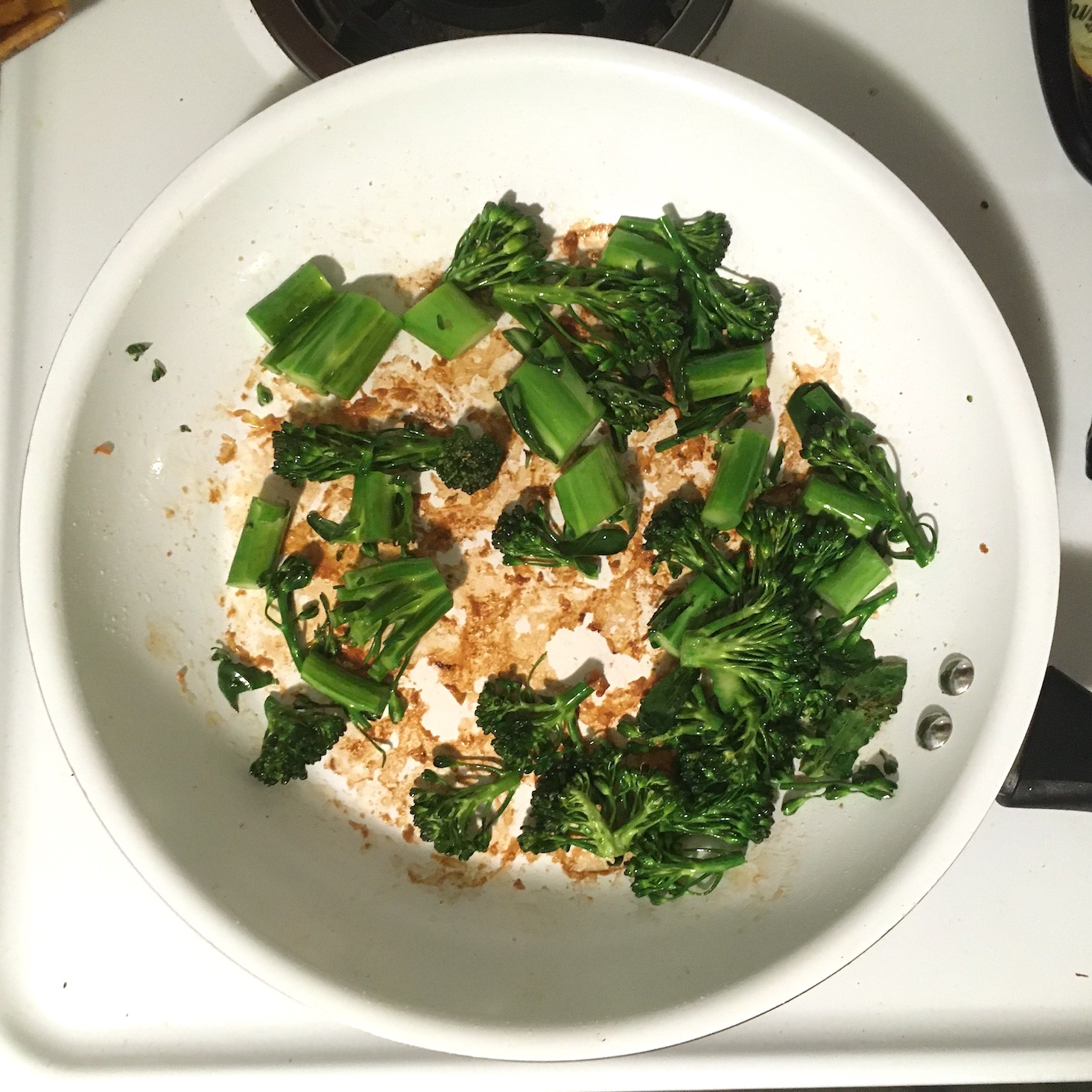 tomato shrimp pasta broccolini cooking in pan