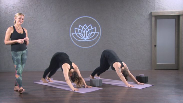 Woman teaching yoga class.