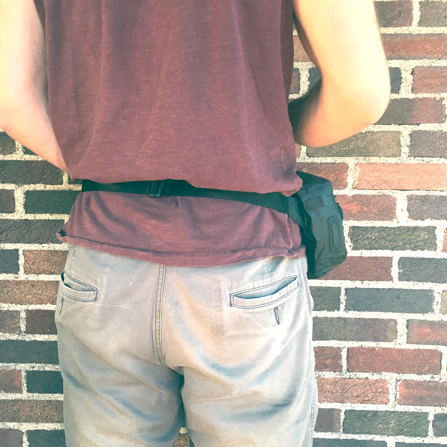 Cairn August 2020 man wearing fanny pack, back view