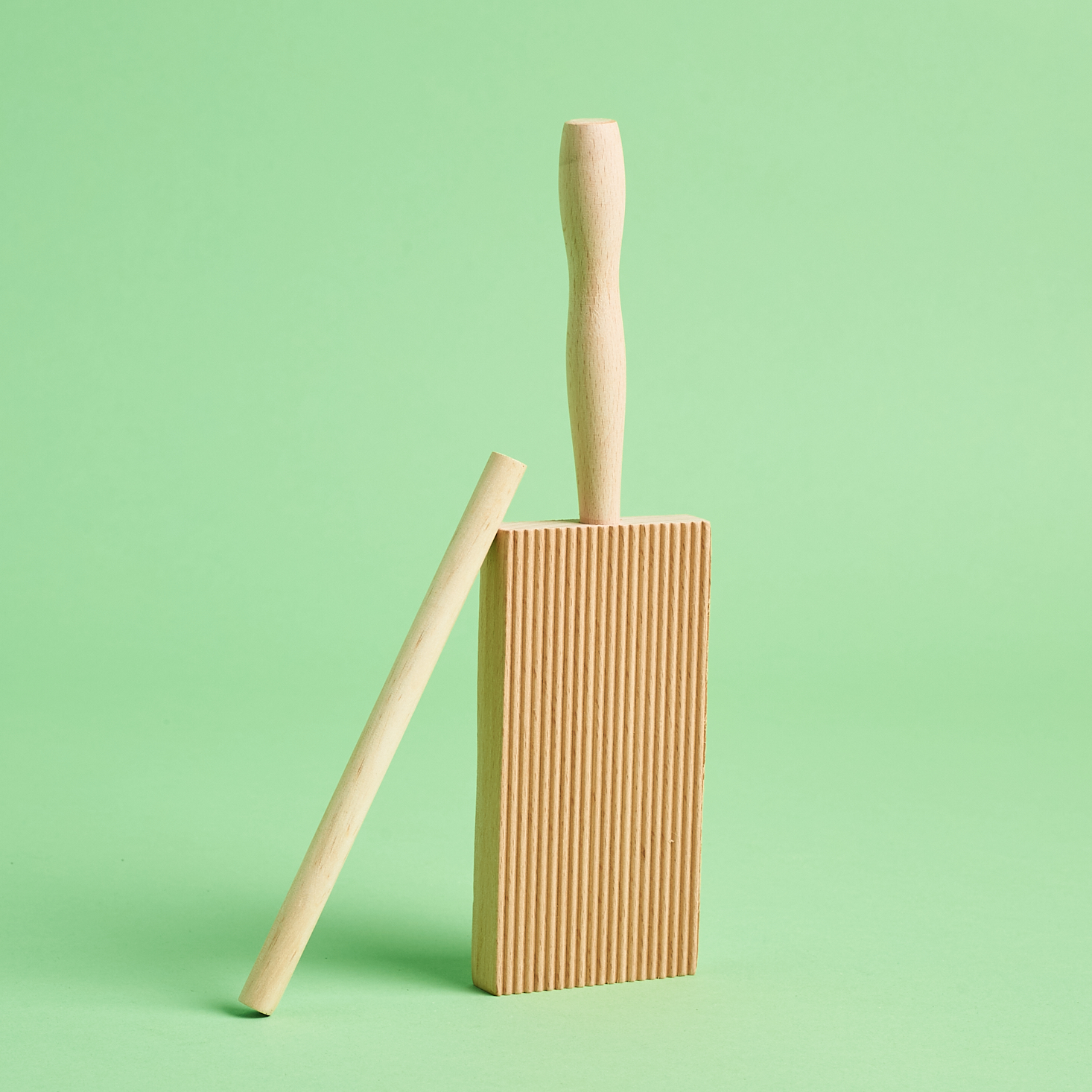 Wooden pasta shaper set standing on edge