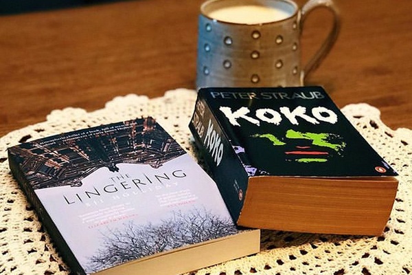 Two thriller novels on a dining room table.