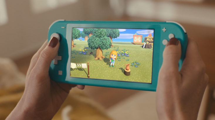 Woman's hands holding Nintento Switch Lite Turquoise