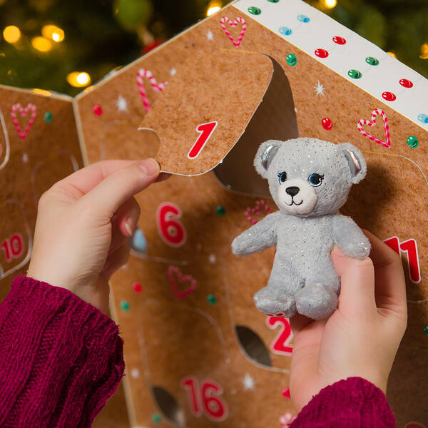 Child opening day 1 of Build-A-Bear 2020 Beary Merry Advent Calendar