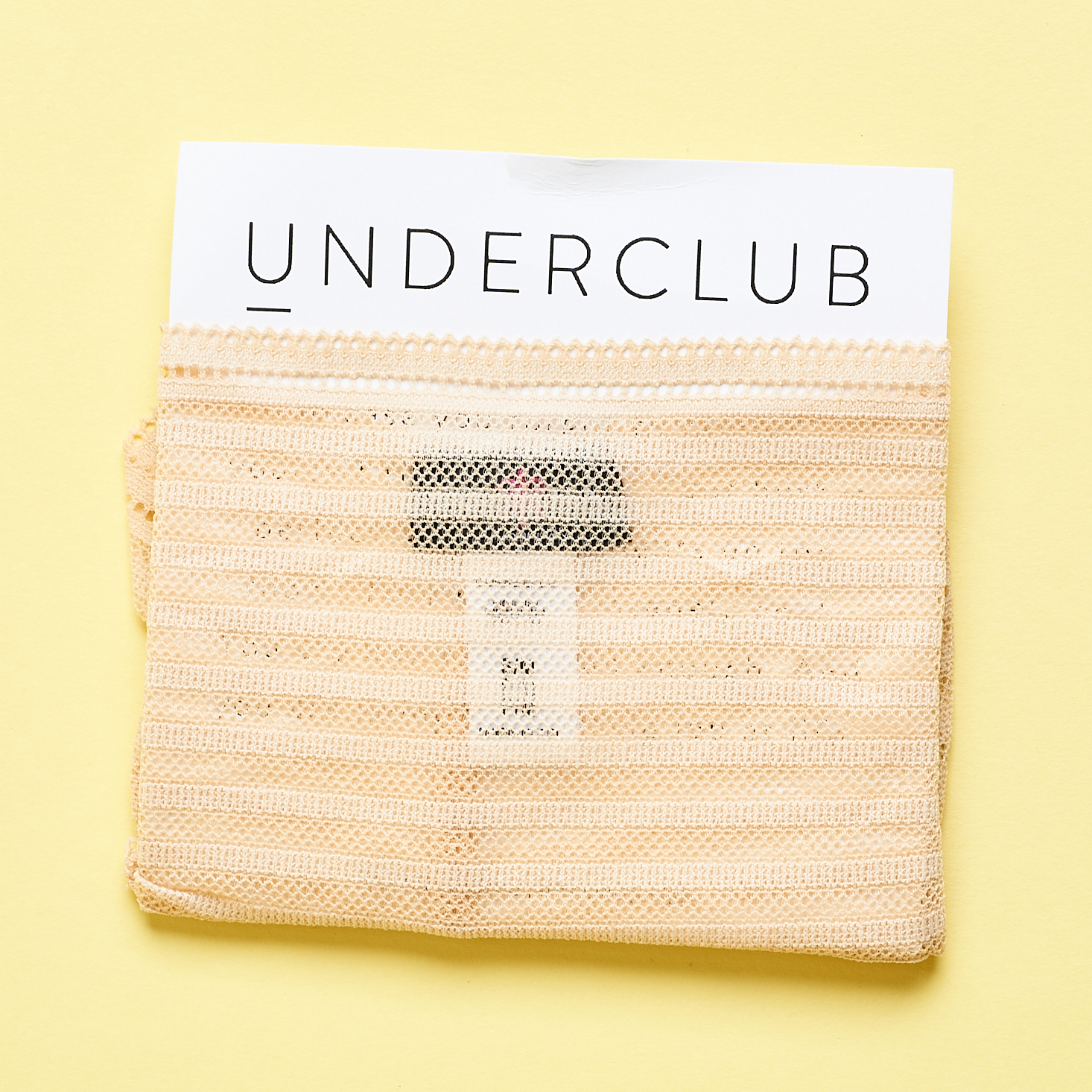 Underclub sheer underwear folded around card