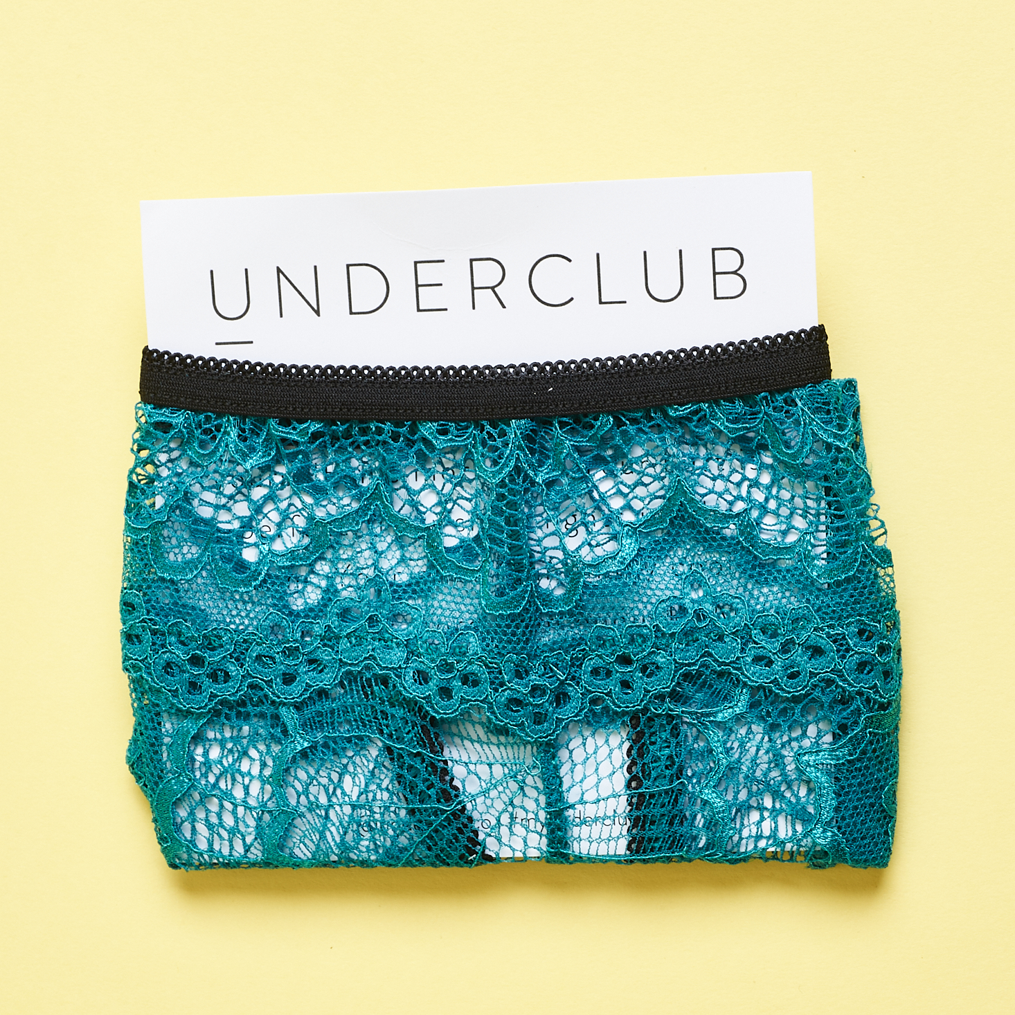 Underclub teal lace underwear wrapped around card