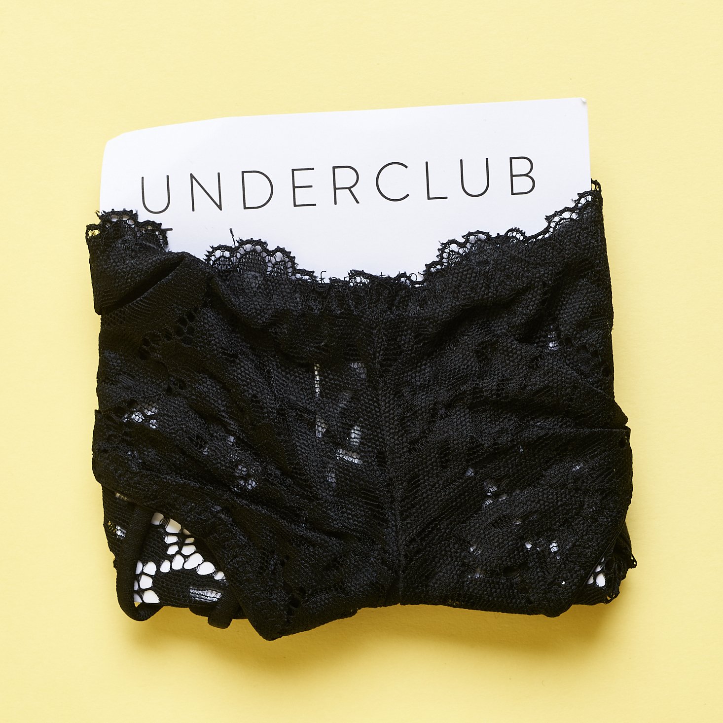 Underclub black lace underwear wrapped around card