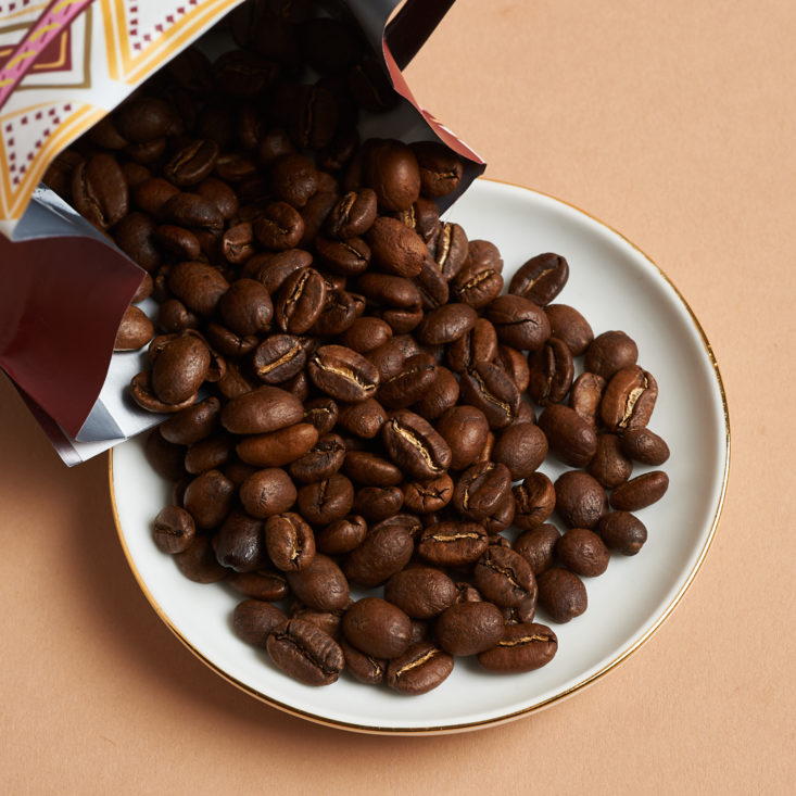 coffee beans being poured out onto a plate
