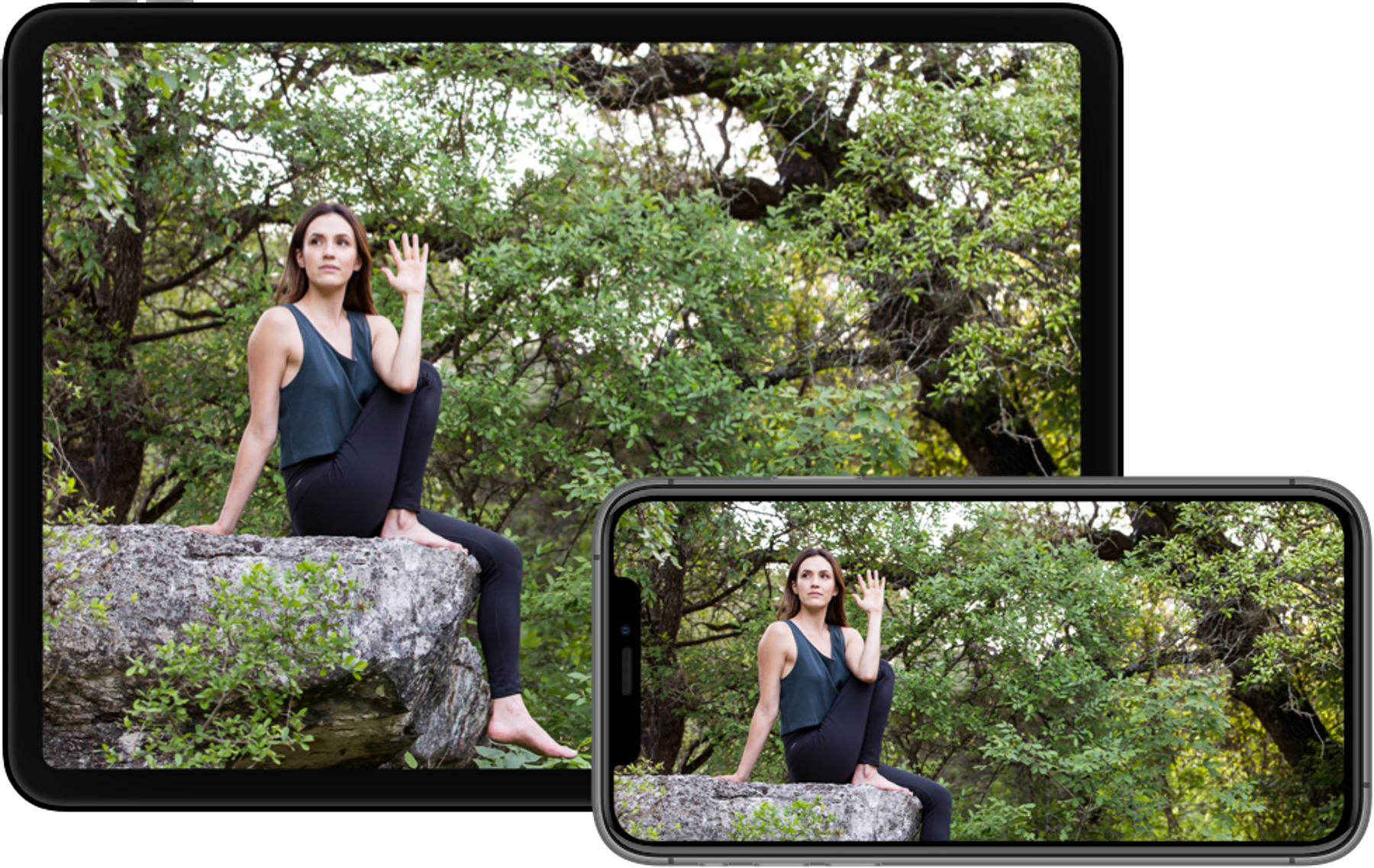 yoga instructor does pose on a rock in nature