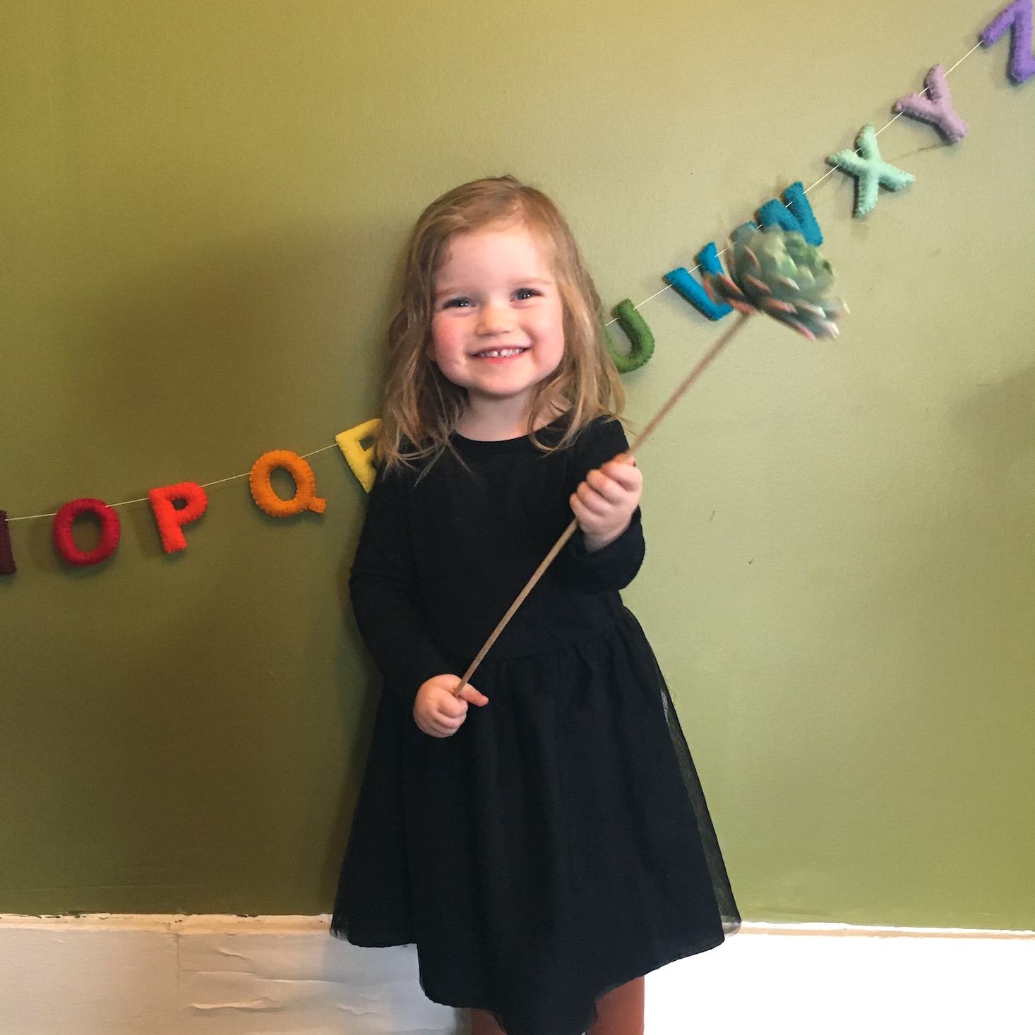 Enjoy Flowers kid holding succulent on dowel from the bouquet