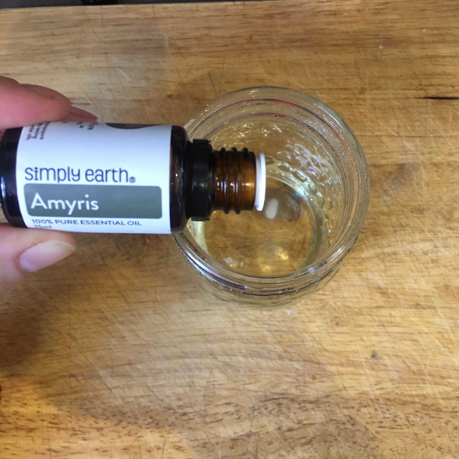 Adding Amyris essential oil to my wax blend.