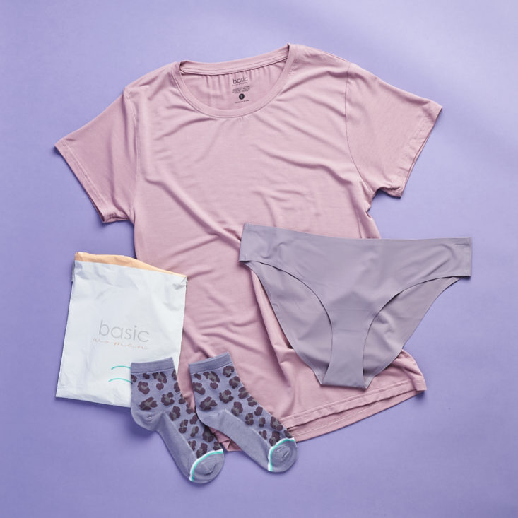 woman's undershirt, underwear and socks on a purple background