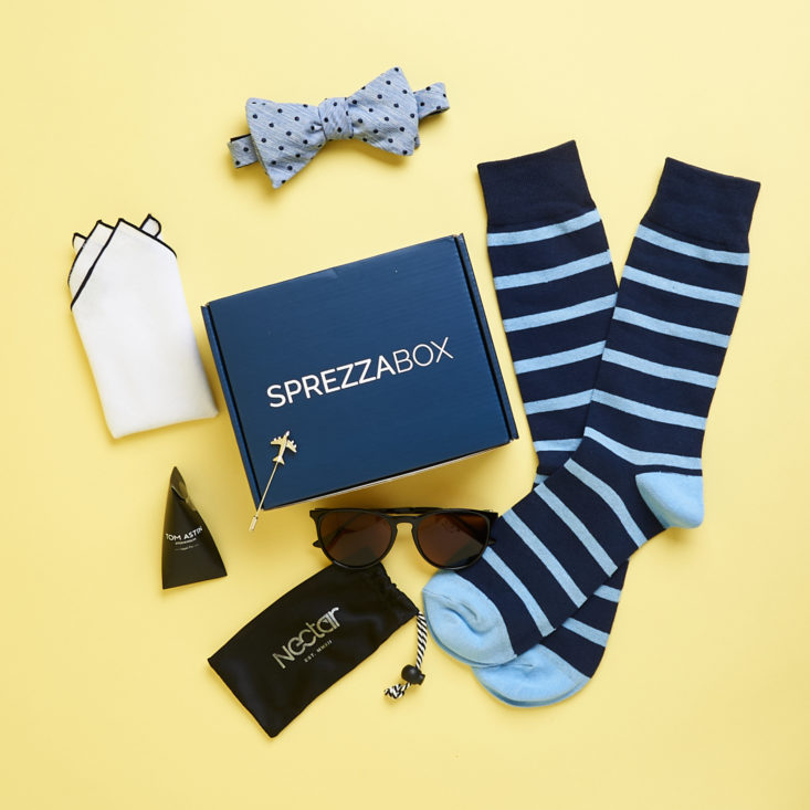 sprezza box surrounded by socks, tie, sunglasses, and other men's fashion items