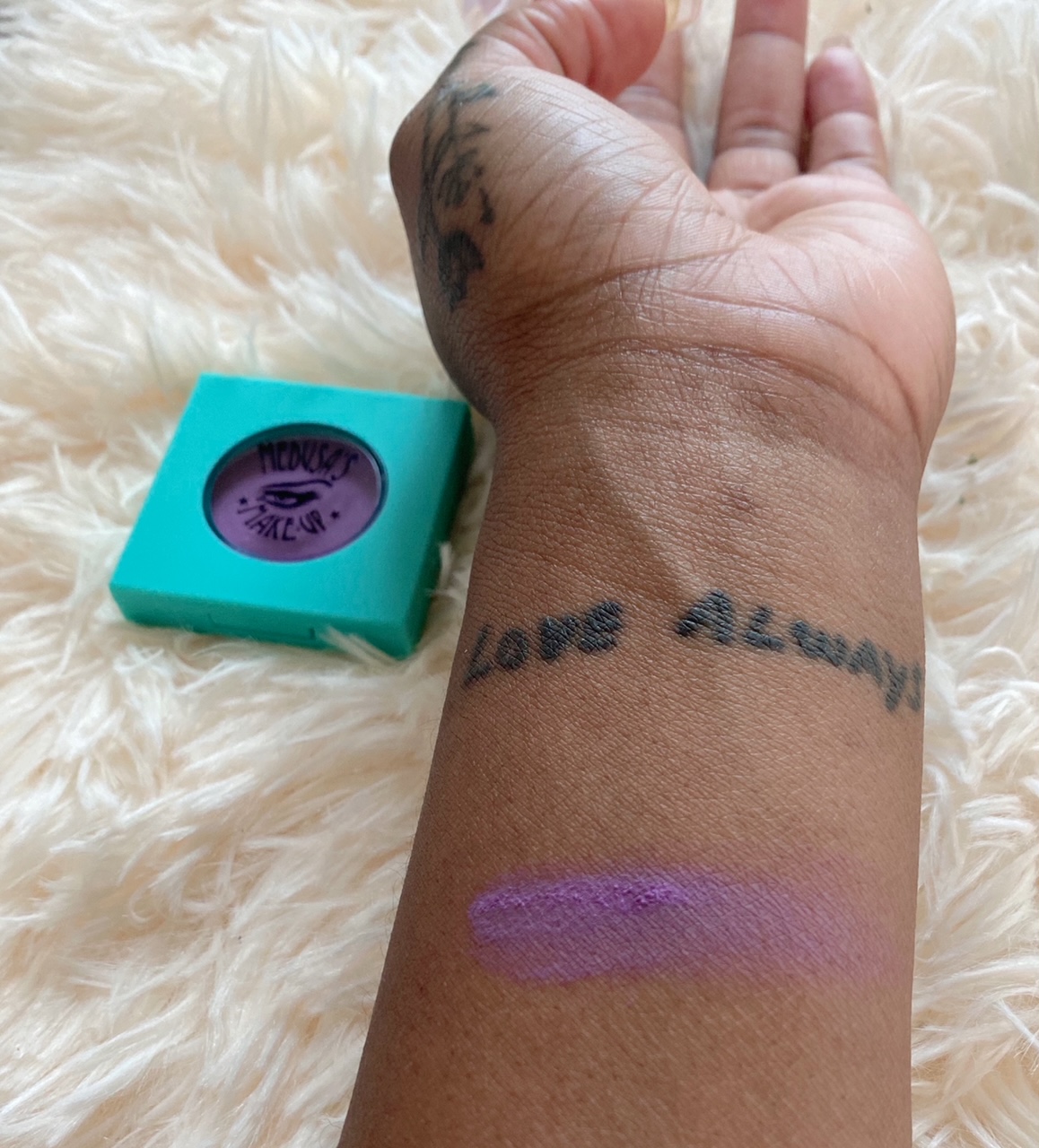 Montego bay shadow is swatched on arm. Color is bright purple.