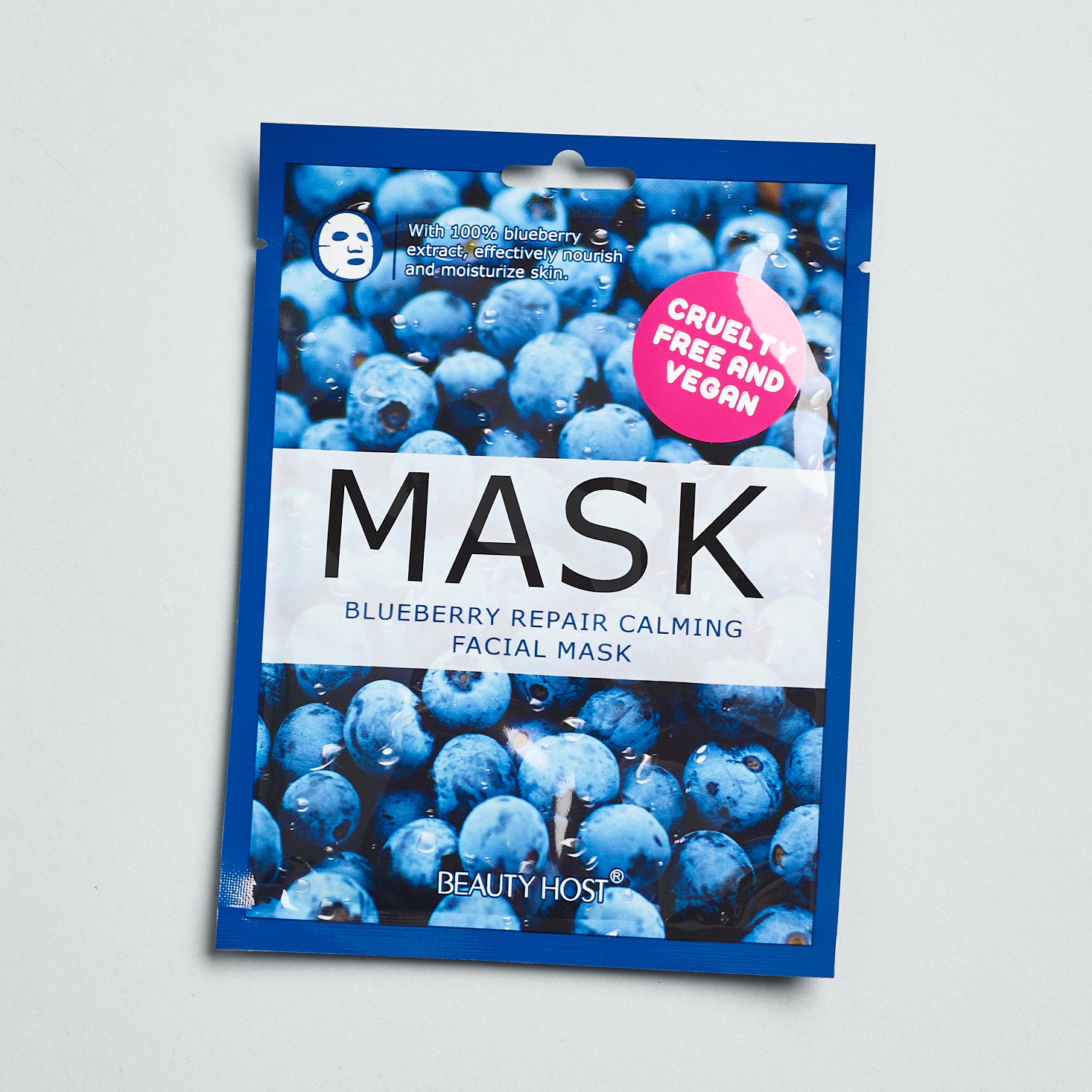 Front of blueberry mask packaging. images of blueberries