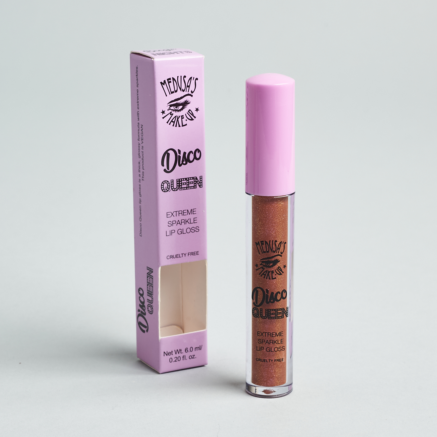 Disco Queen lipgloss unpackaged. Tube stands next to box