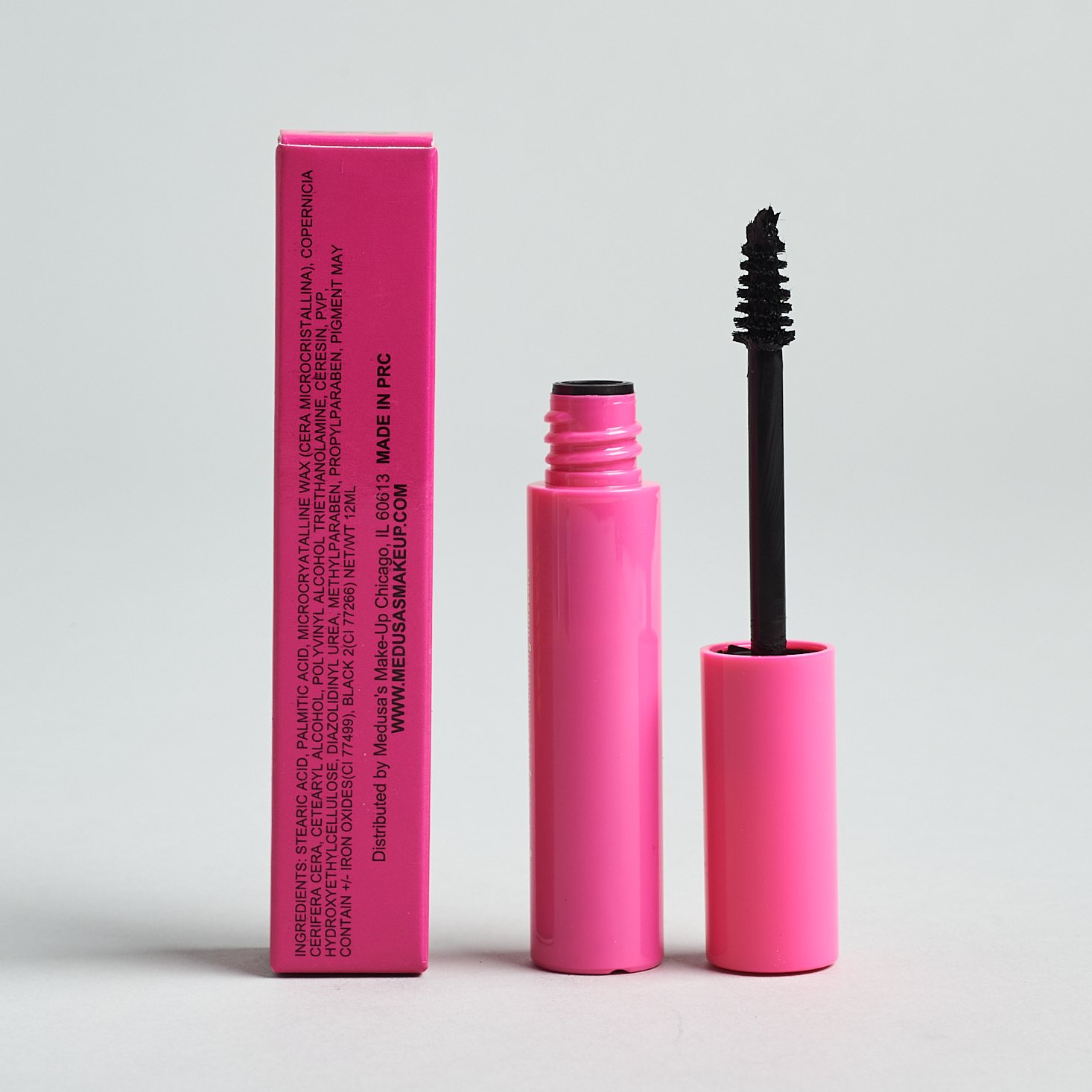 Unopened mascara. The lid is next to it showing a wide bristled wand.