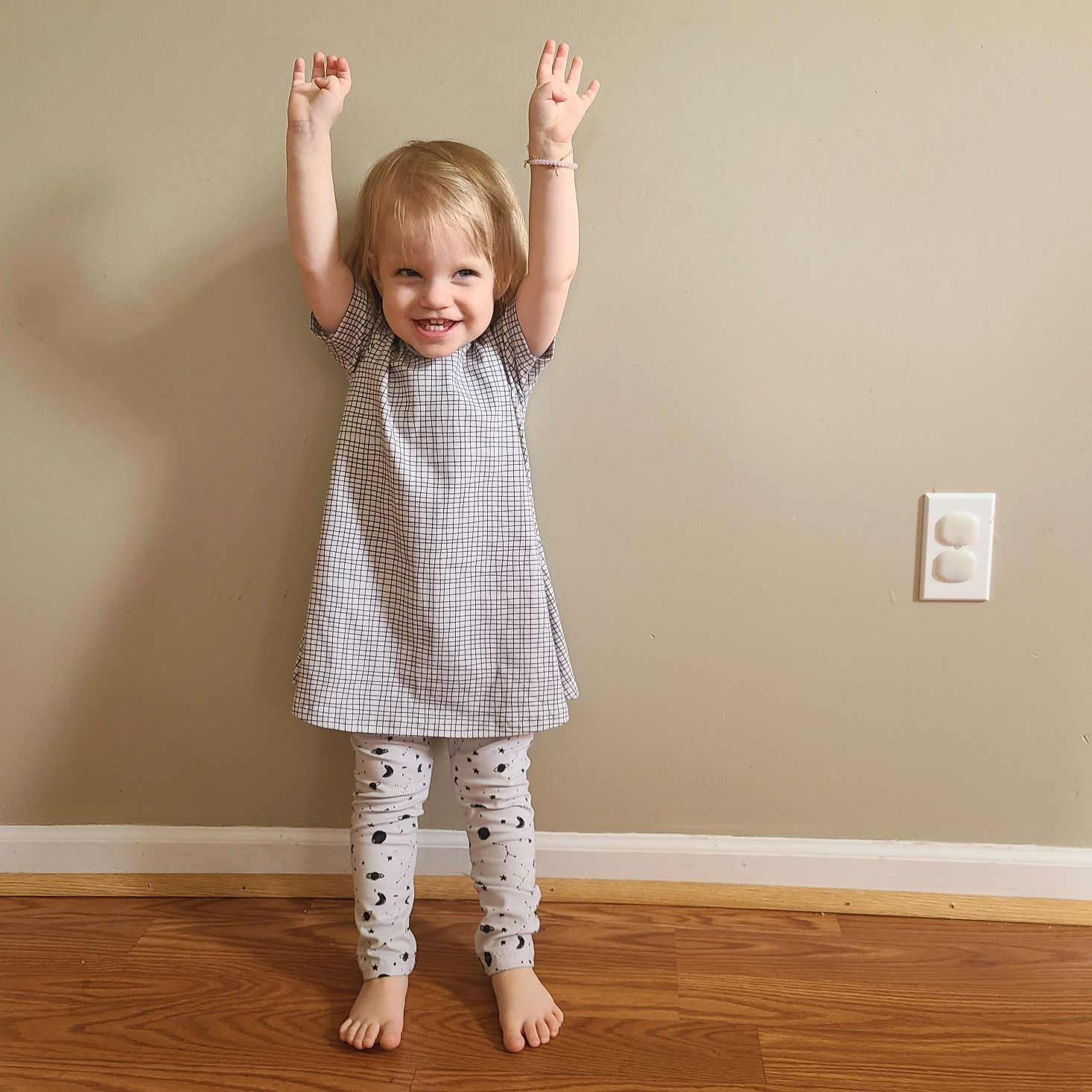 Suprisly May 2021 tee dress and space print leggings modeled on little girl