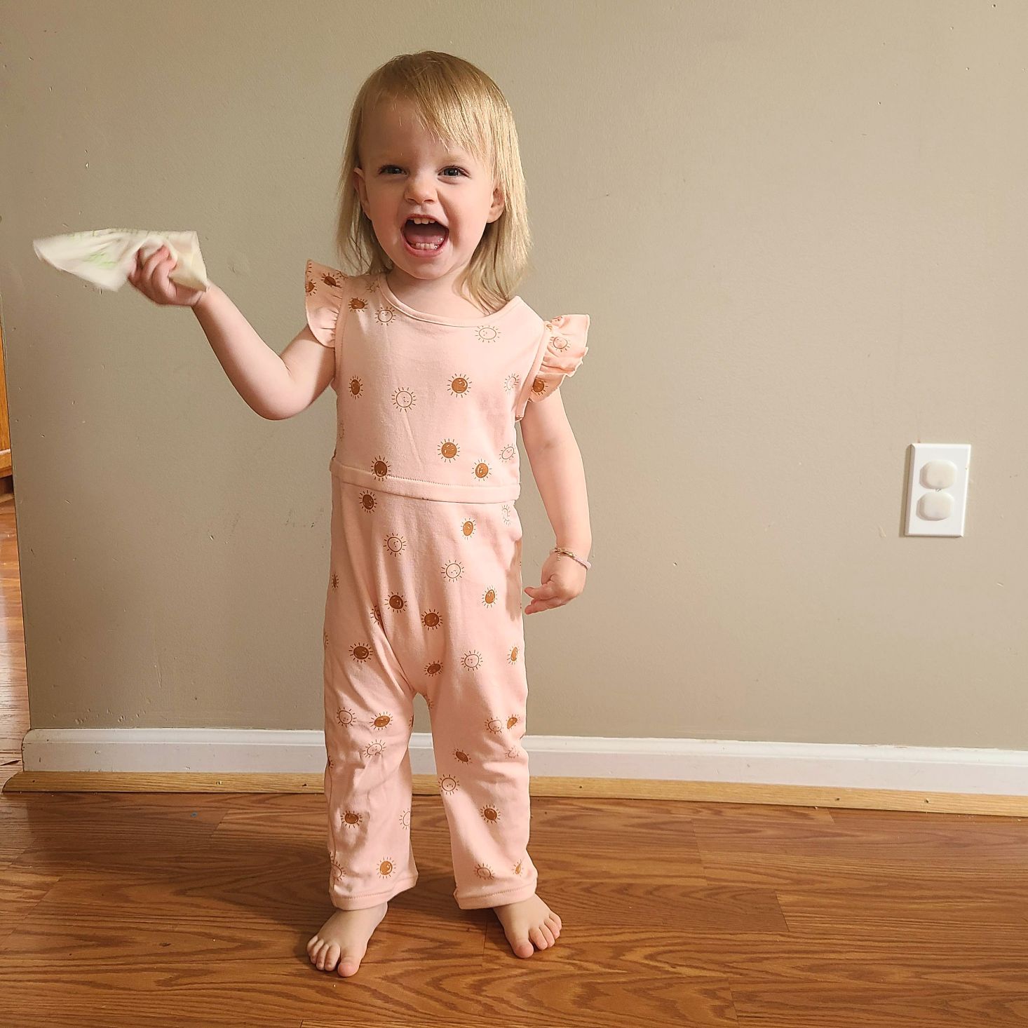 Suprisly May 2021 pink romper with ruffle shoulders modeled on little girl 2