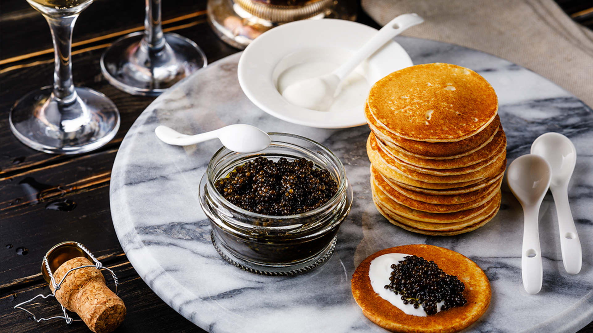 Black Caviar, Mini Pancakes and Sour Cream Holiday Party Appetizer on dark background