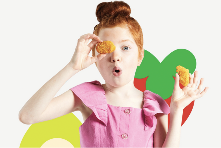 little girl holding chicken nuggets