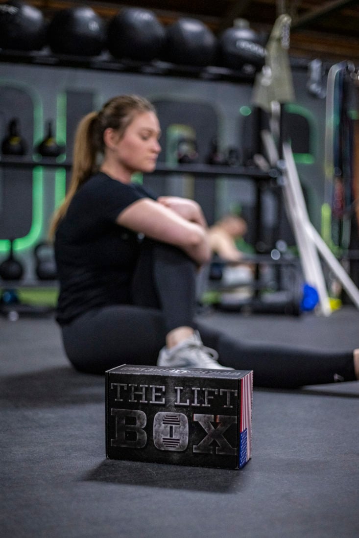 The Lift Box in foreground with woman stretching in the background.