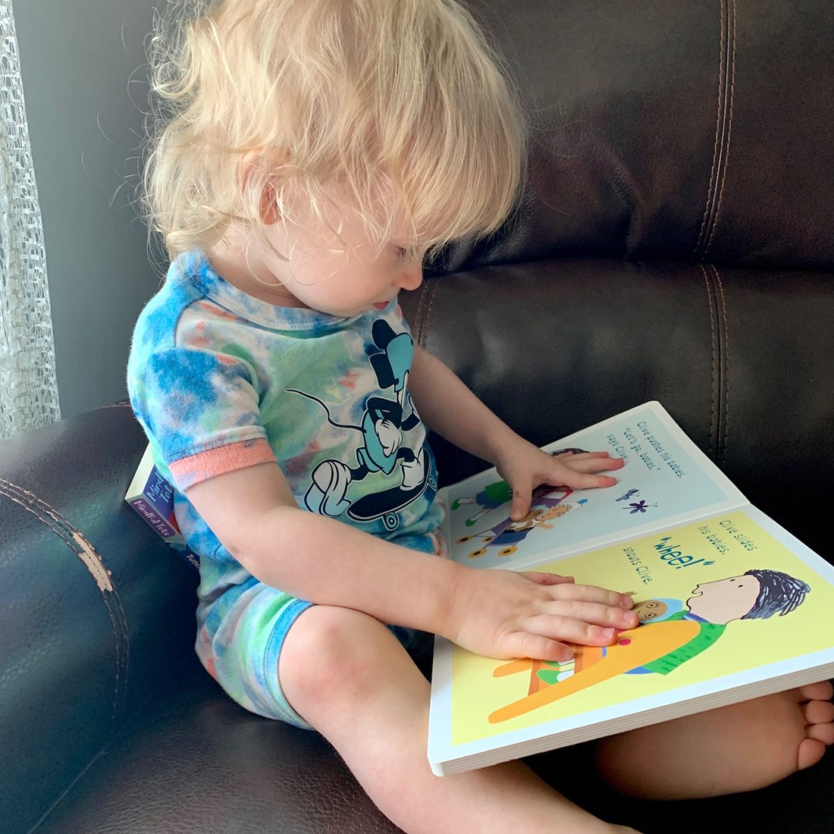 child reading Little Feminist book