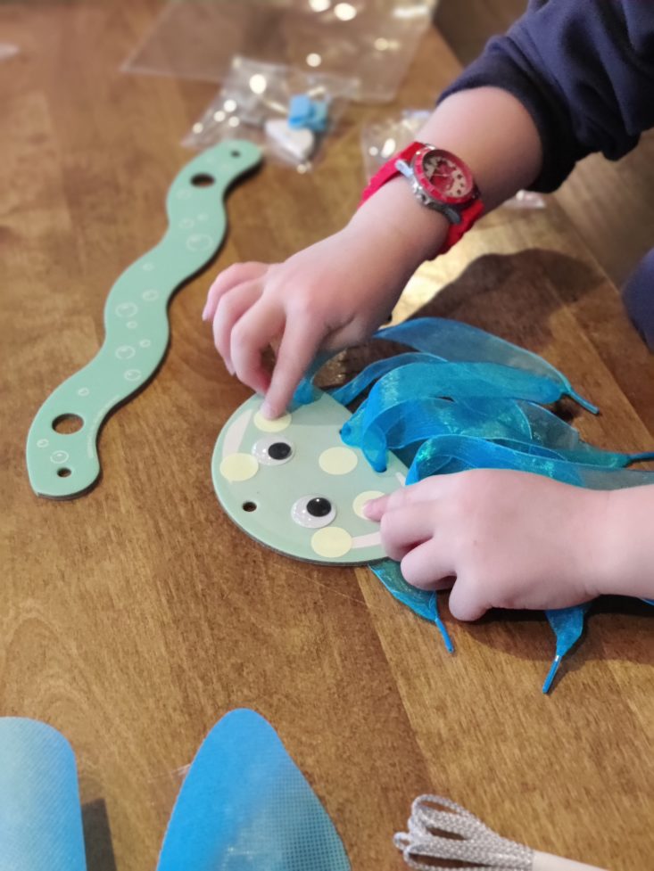 Boy making a jellyfish from a KiwiCo project