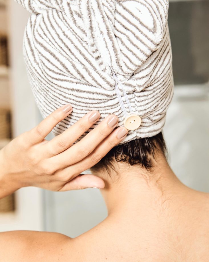 Photo of back of woman's head; she is wearing the Bemakai Manta Hair Towel Wrap