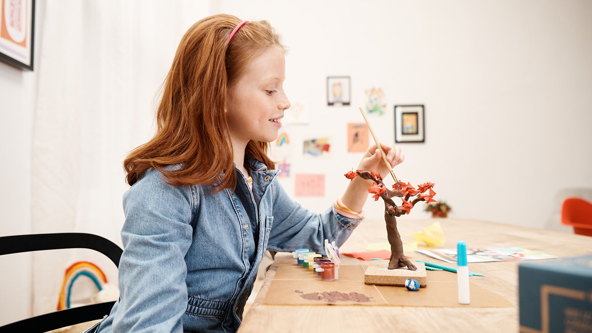 Photo of red-haired girl painting tree from KiwiCo crate