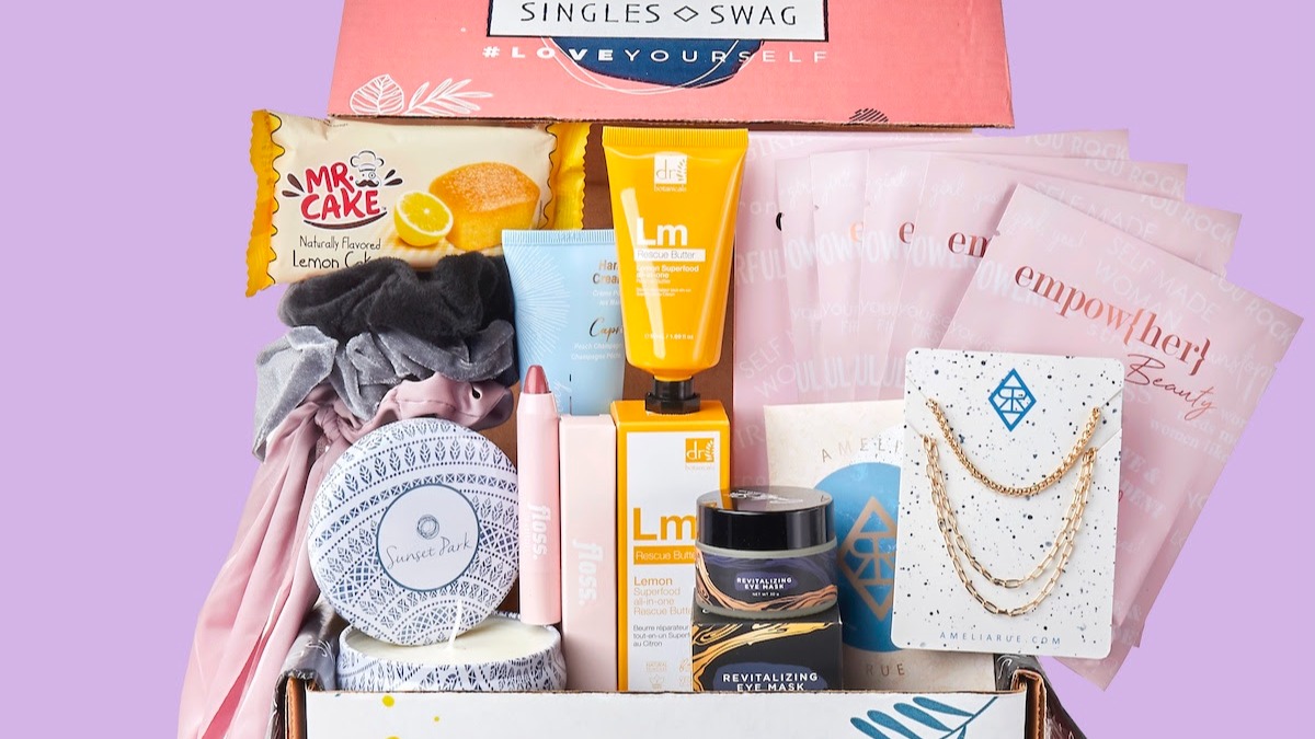 Photo of September 2021 Singles Swag merch including book, snacks, jewelry, makeup