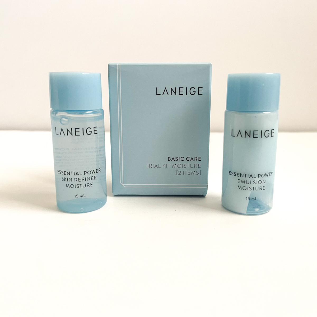 small blue laneige samples next to blue packaging on white background