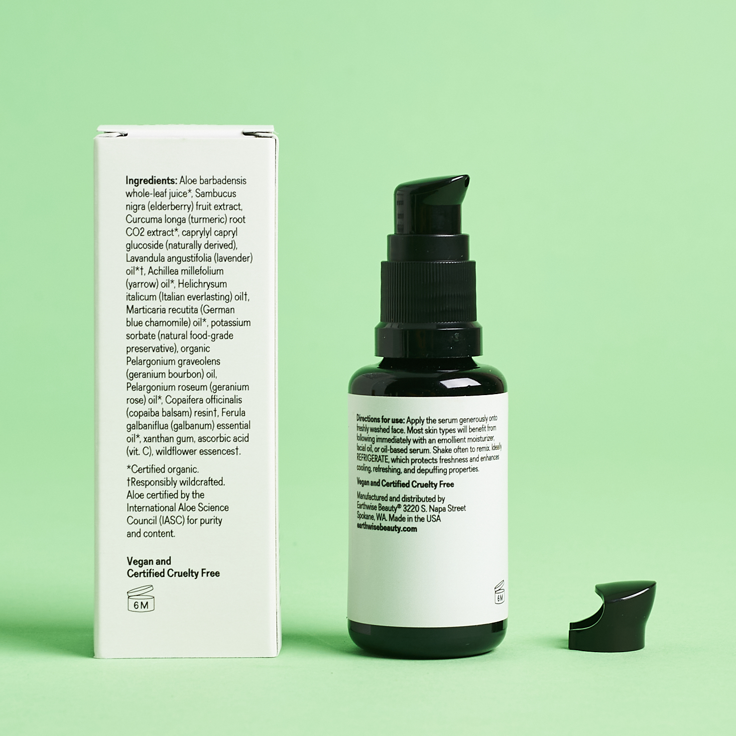 black and white serum bottle next to white packaging turned so you can read the ingredients