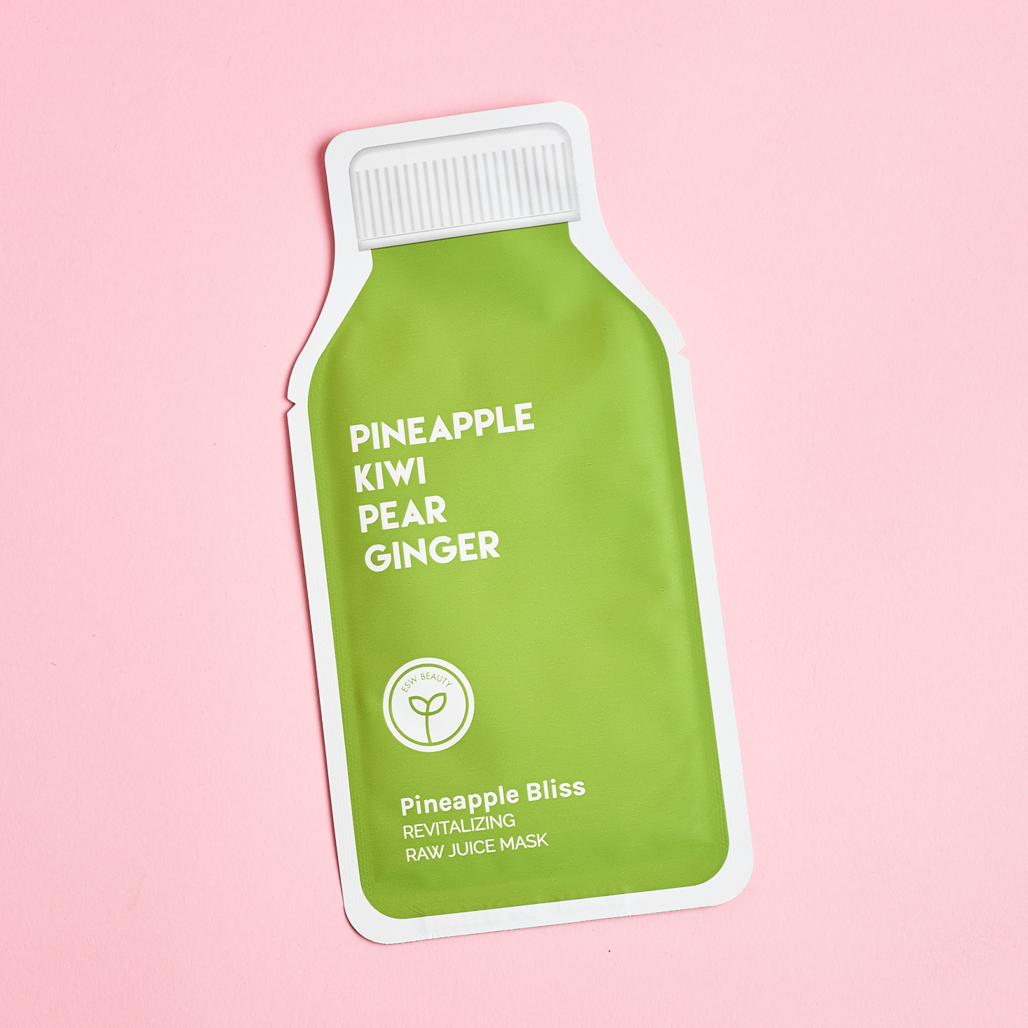 front of green sheet mask in the shape of a juice bottle