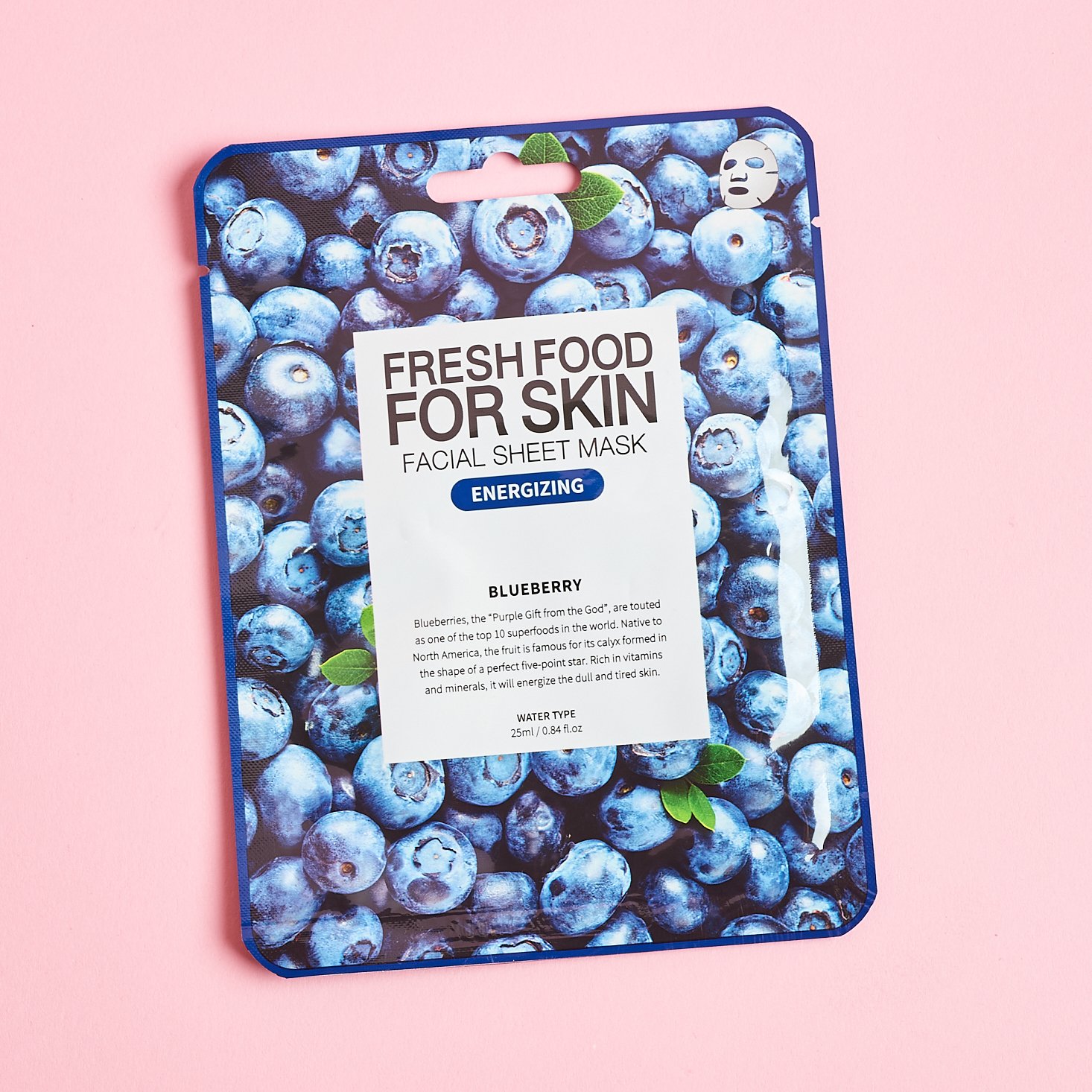 front of blue sheet mask with blueberries over it