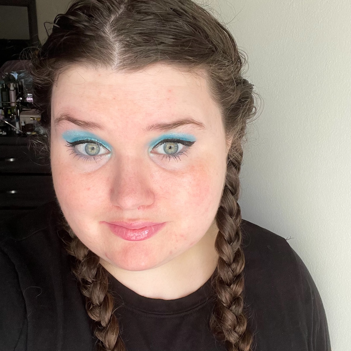 makeup look featuring sparkly blue eyeshadow and nude lip
