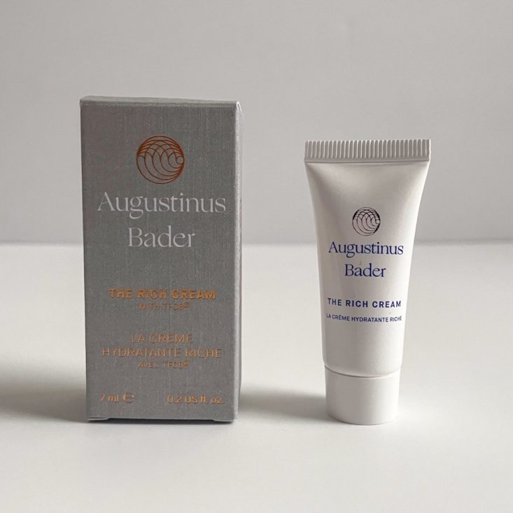 white tube of moisturizer next to grey box