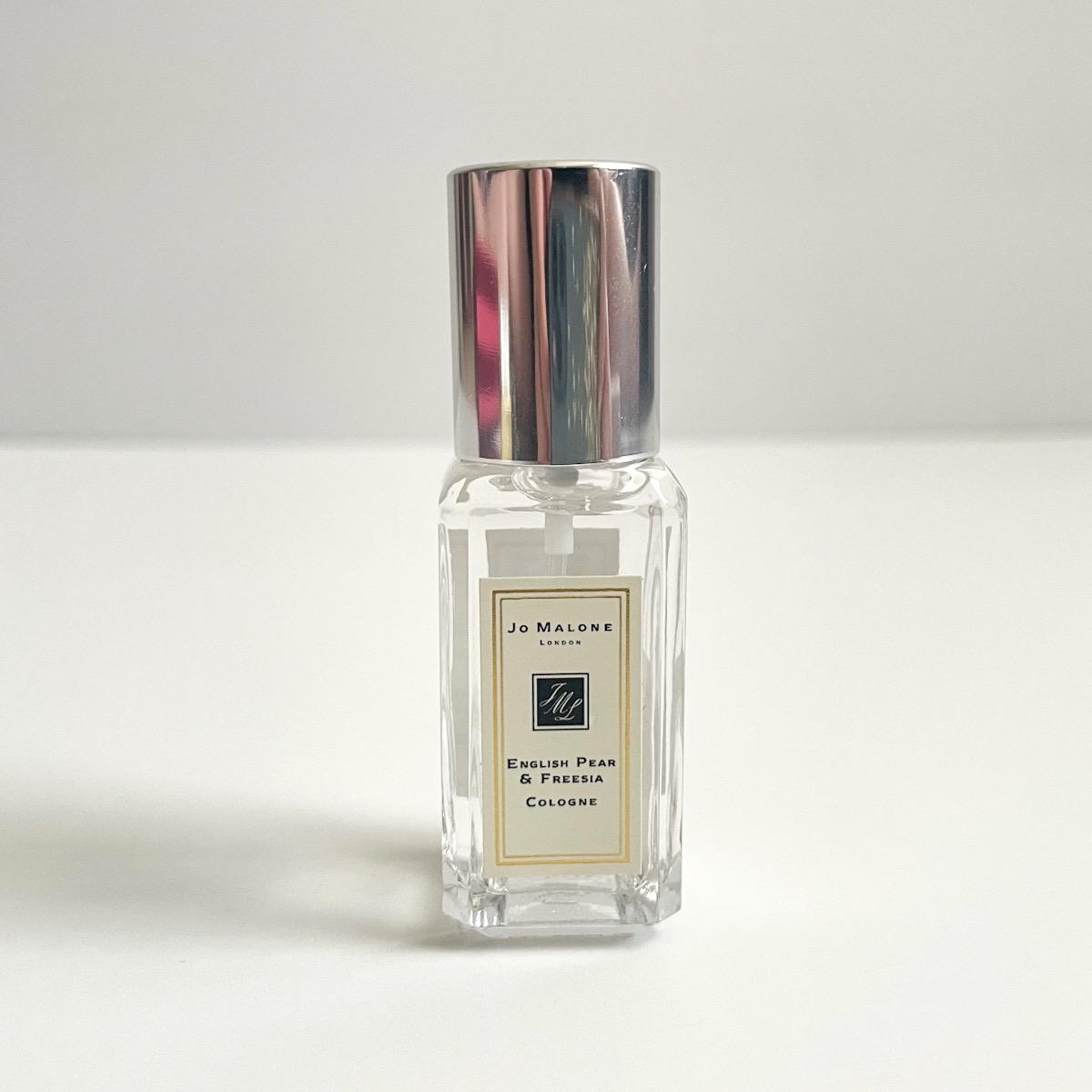 clear glass perfume bottle with white label