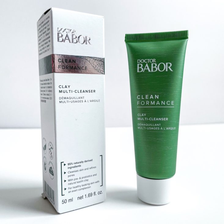 green tube of cleanser next to white and silver box