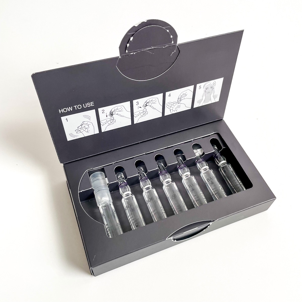 opened black box showing seven clear glass ampoules