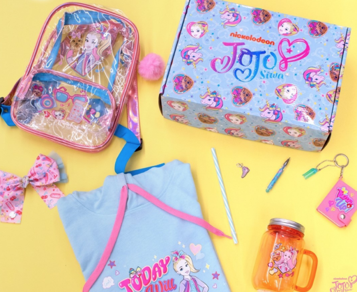 jojo siwa box and items from the box around it on a yellow background