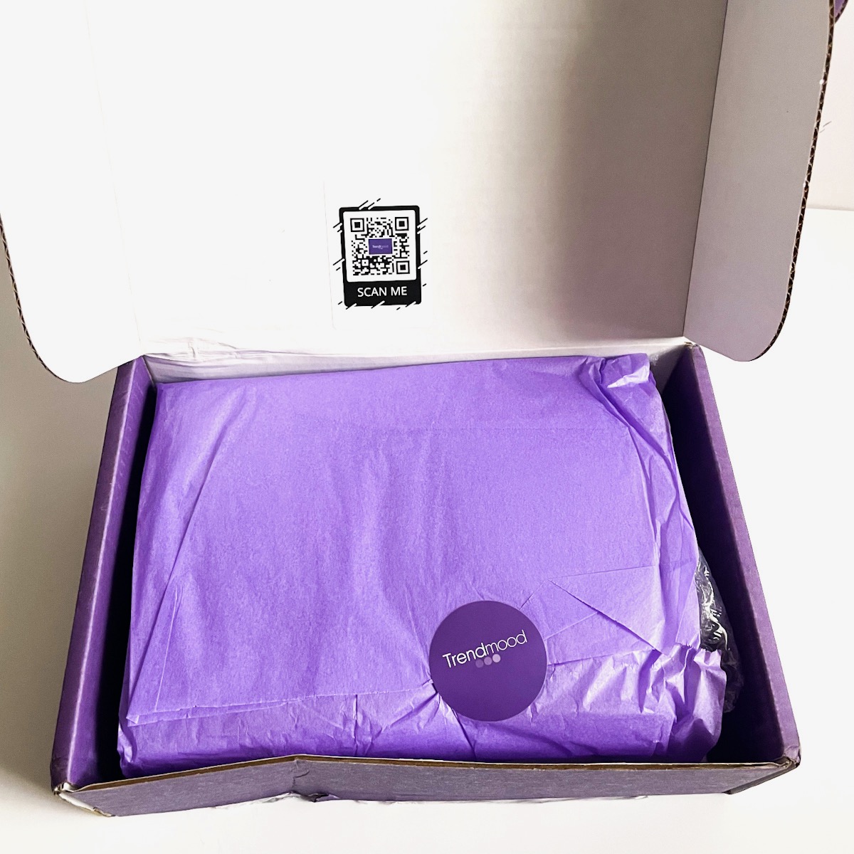 open box showing purple tissue paper and Trendmood sticker