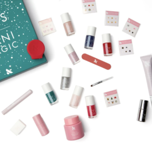 8 nights of mani magic kit from olive and june with nail polishes and other accessories on a white layflat
