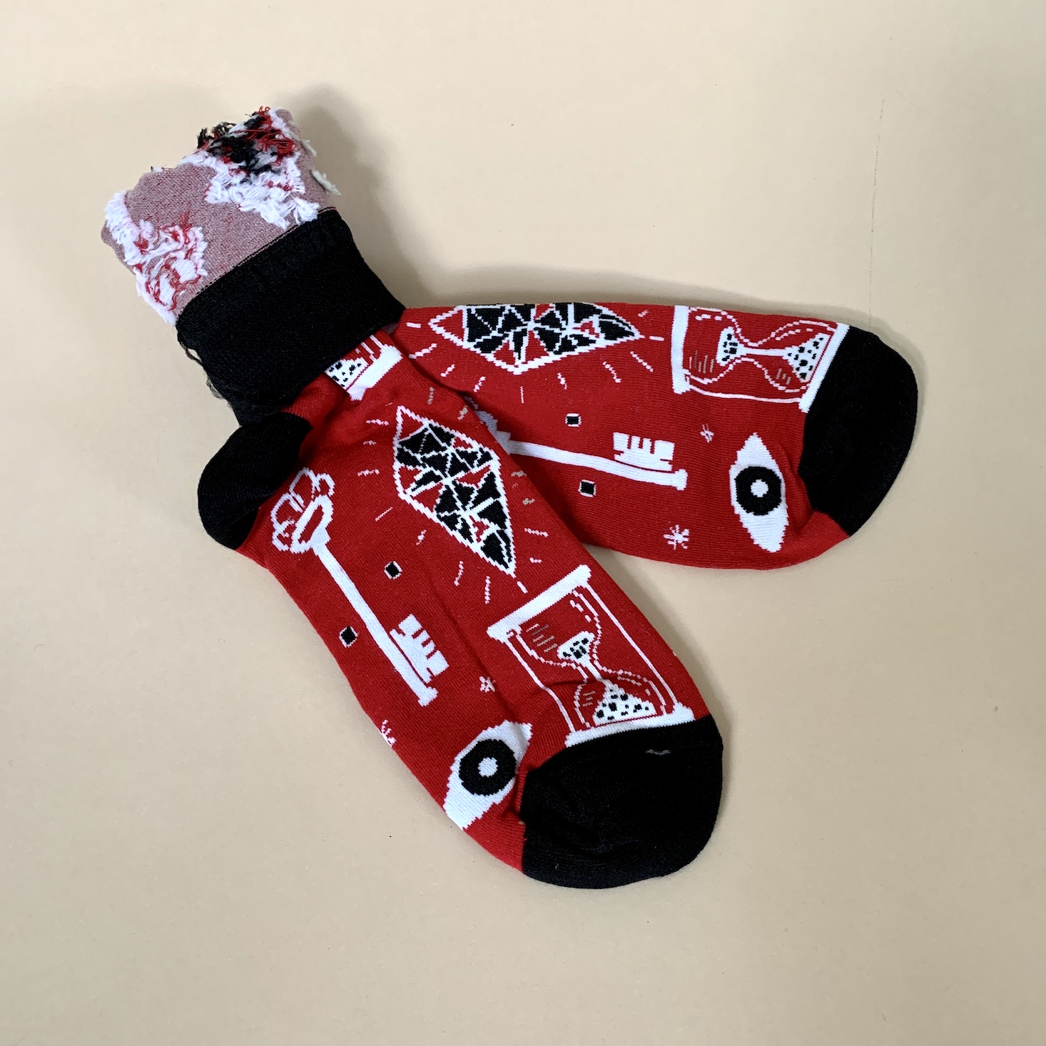 palm reading pair of socks, red with black background and different designs