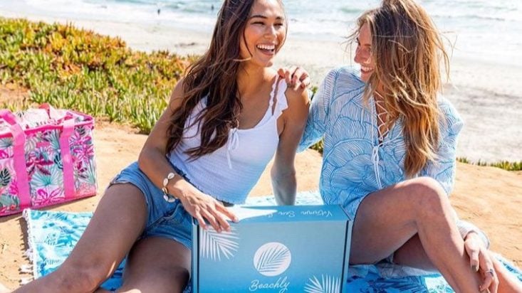 photo of two women on the beach with a Beachly box