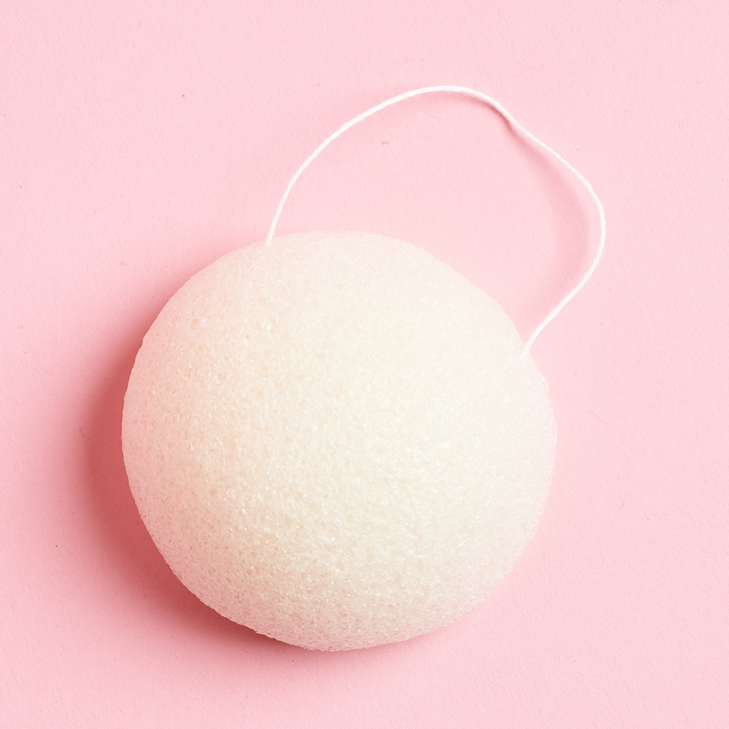 white konjac sponge with loop to hang it