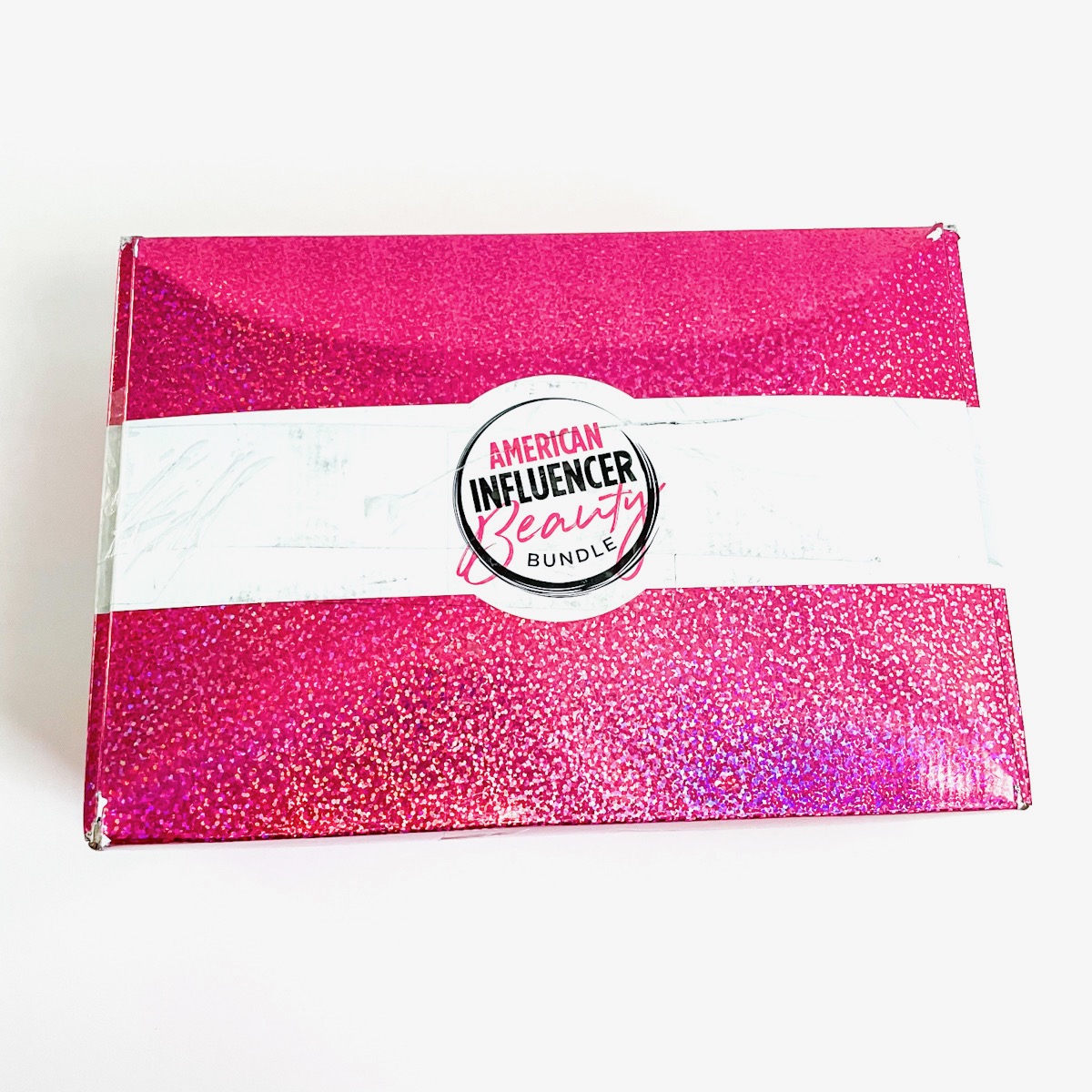 sparkly pink and white box on white background