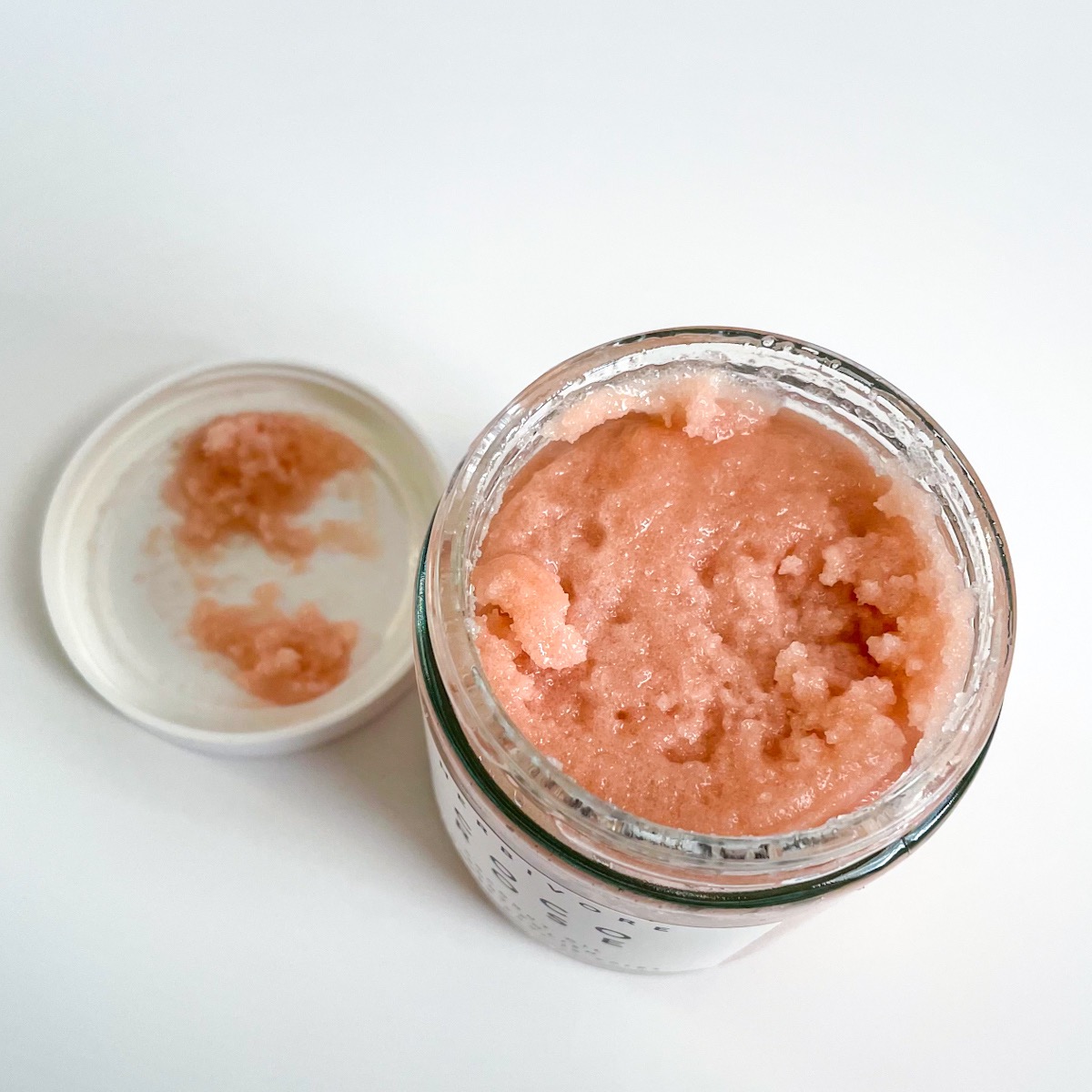 opened jar showing pink scrub texture