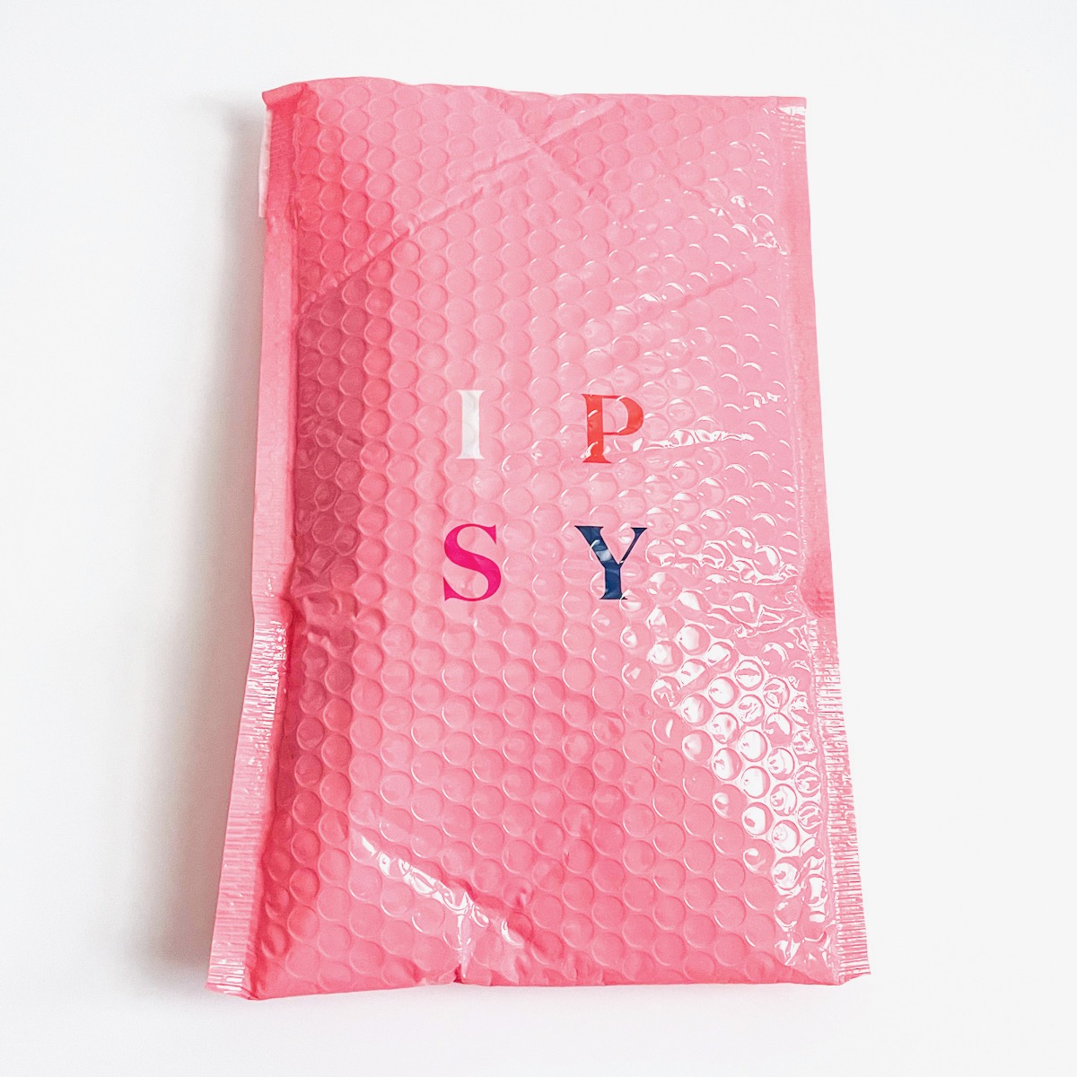 pink bubble mailer with Ipsy logo on white background