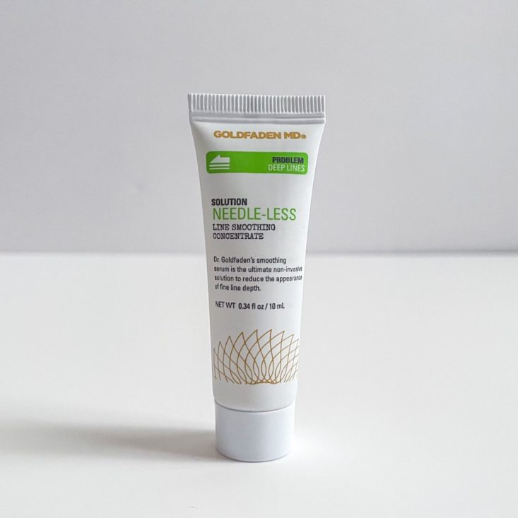 white and green tube of serum on white background